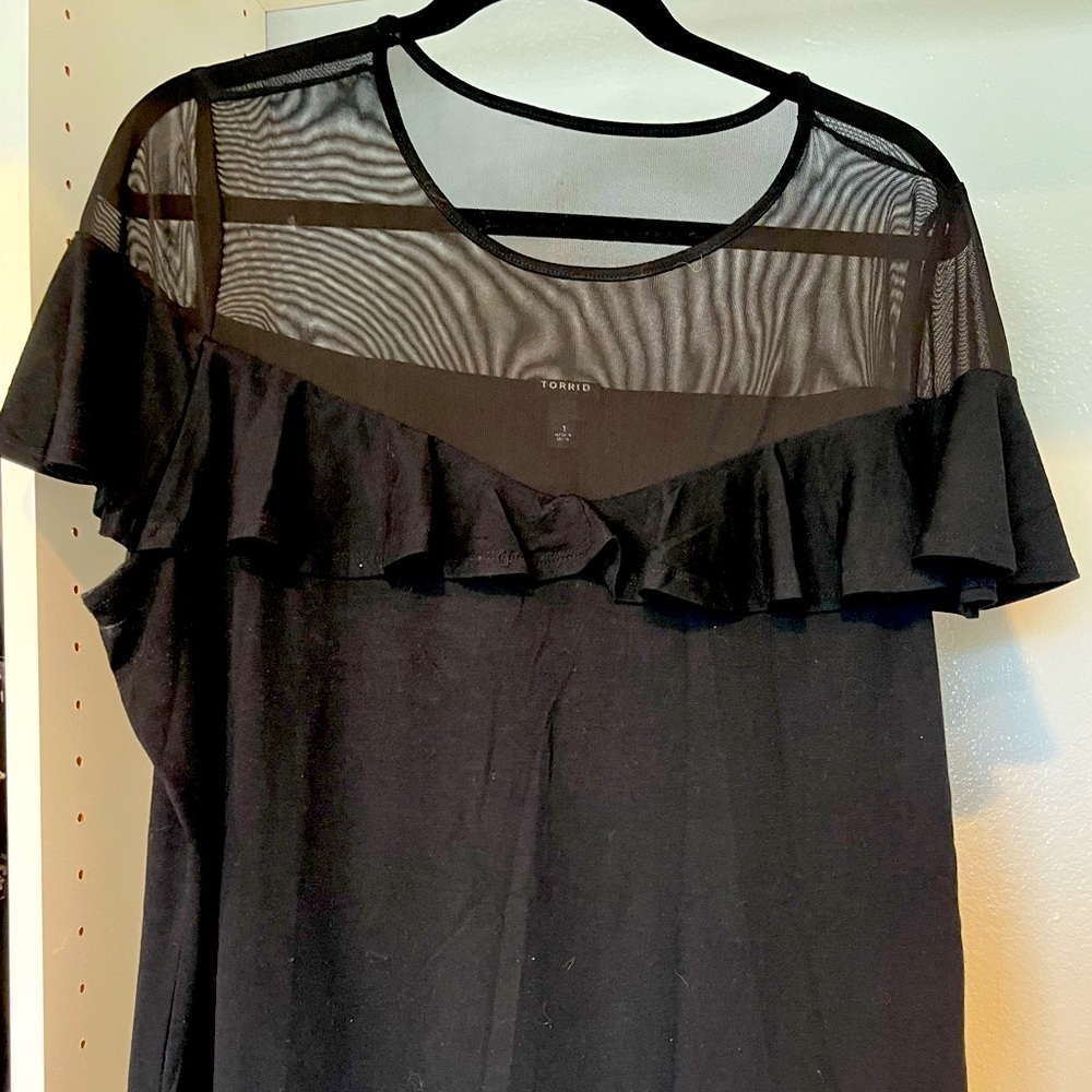 Black top with mesh and ruffle accent